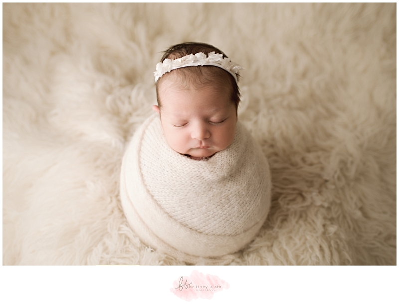Calgary Newborn Photographer baby girl on white flokati potato sack pose